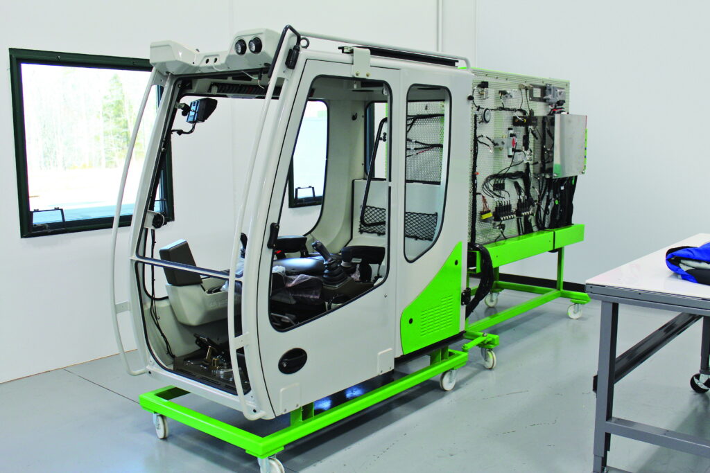 The Operator Machine Familiarization Program starts with time in this cab at the Training Center.
