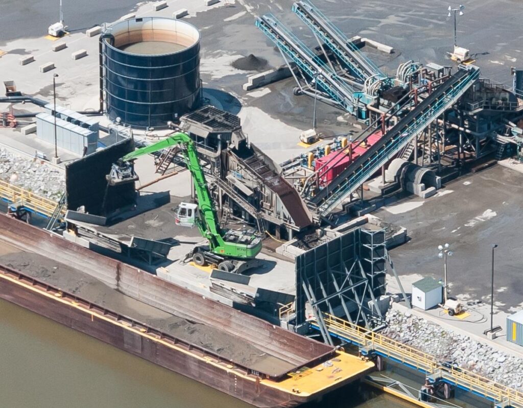 The 870 machines combine speed and precision to clean out the lightweight barges without damaging their hulls.