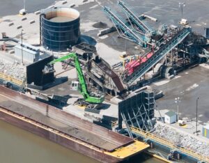 The 870 machines combine speed and precision to clean out the lightweight barges without damaging their hulls.