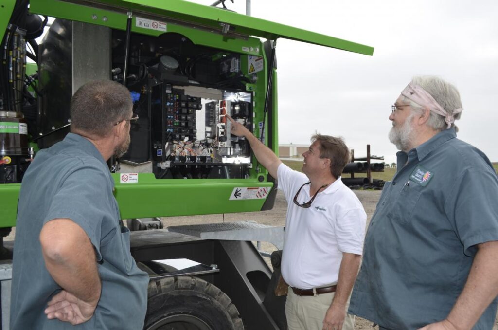 Ryan Zenor of SENNEBOGEN shows the electric relay featured on the SENNEBOGEN 818 E to Pinellas County employees.